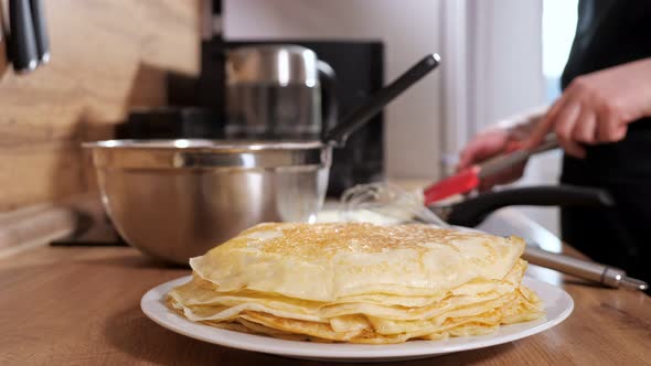 Unrecognizable Woman Puts a Readymade Pancake with a Spatula in a Stack Slow Motion