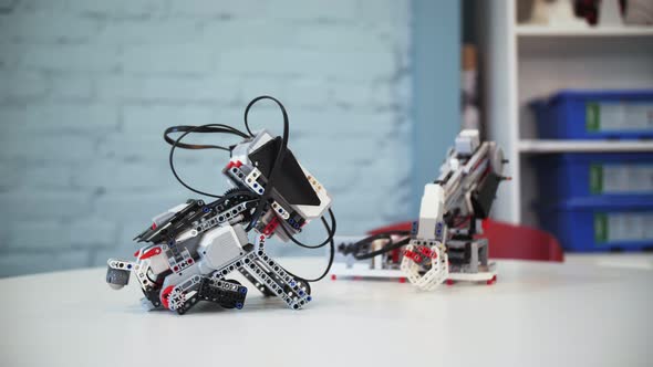 assembling a model of robotics from plastic toy blocks