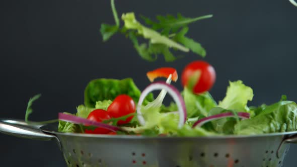 Fresh Salad Flying to Colander in Super Slow Motion