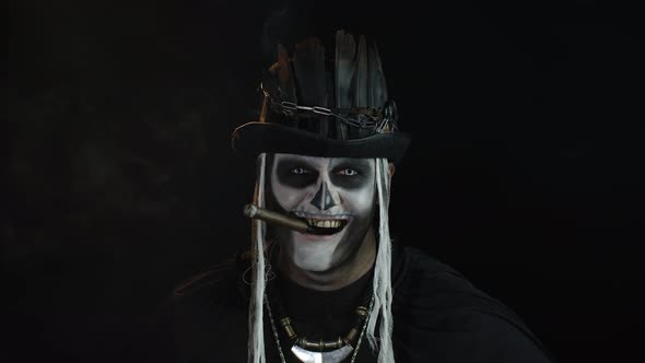 Frightening Man in Skeleton Halloween Cosplay Costume Smoking Cigar, Smiling, Laughing. Slow Motion