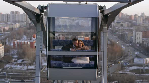 Loving Couple Riding Ferris Wheel