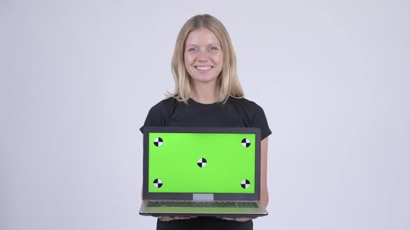 Young Happy Blonde Woman Thinking While Showing Laptop