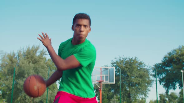 Athletic Black Man Playing Basketball Outdoors