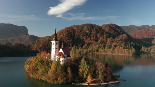 Amazing Aerial View of the Colorful Forest and Lake Bled with a Small Island with a Church. Sunrise