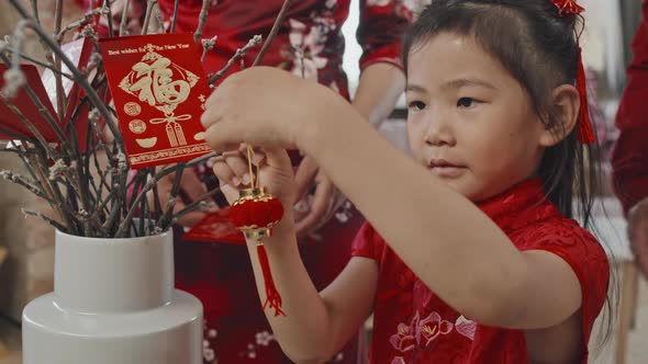 Chinese Girl Decorating for Lunar New Year