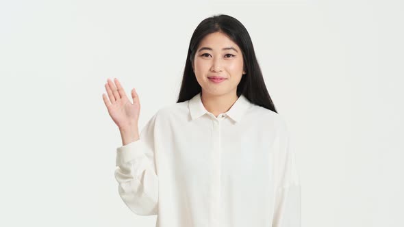 Beautiful asian korean woman doing hello gesture