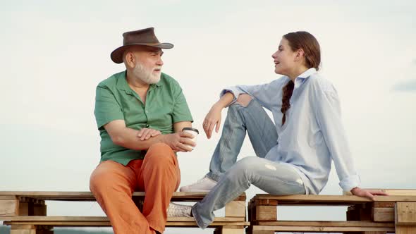 Granddaughter with Elderly Kind Grandfather Outdoor. Old and Young. Daughter with Mature Father