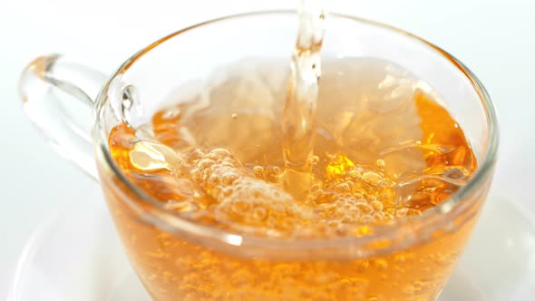 Super Slow Motion Shot of Pouring Tea on White Background at 1000 Fps