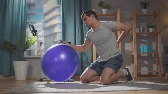 Severe Pain in a Man During a Fitness Class on a Gym Ball at Home