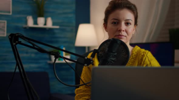 Social Media Influencer Smiling at Camera Sitting in Home Studio