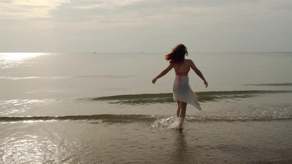 cheerful woman in bikini enjoying on the sea beach with sunlight