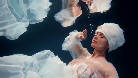 Stunning Underwater Fairy or Queen of Sea is Floating Under Water Surface in Transparent Water