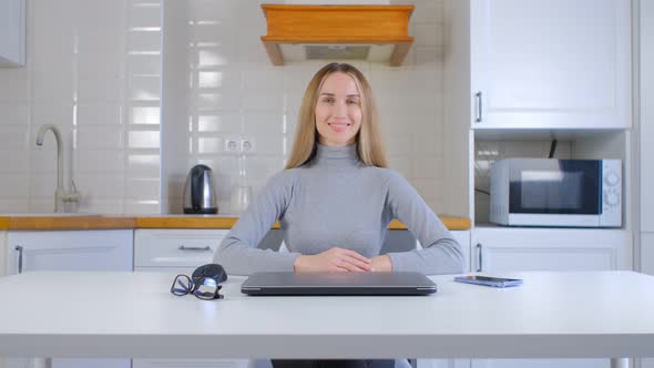 Cheerful white business woman works at home during lockdown with modern computer and internet in 4k