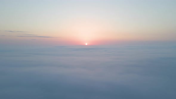 Aerial View From Airplane Window at High Altitude of Dense Puffy Cumulus Clouds Flying in Evening