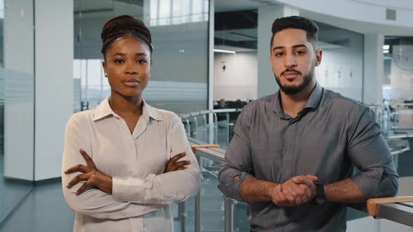 Couple of Two Multiracial Partners Indoors in Office Corporate Company Looking at Camera Answer Yes