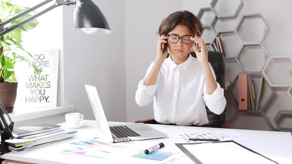 Beautiful Female Designer Explaining Speaking on Phone at Workplace Slow Motion