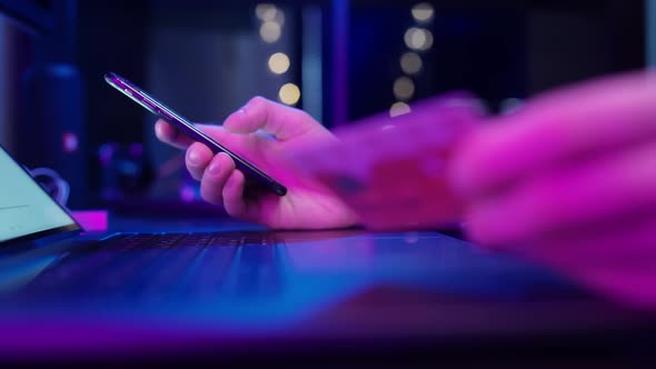 A Man Buying Online Goods and Products While at Home Under Quarantine in the Evening in a Room with