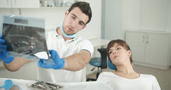 Dentist Showing X-ray To Patient