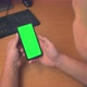 Top view of male hands holding mobile phone with green mock up screen - VideoHive Item for Sale