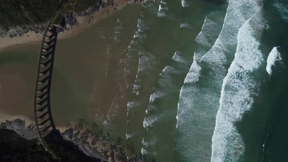 Birds eye drone shot of Wilderness beach in South Africa - drone is descending over the old railway