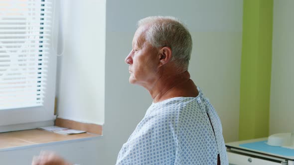 Thoughtful senior man sitting on a bed