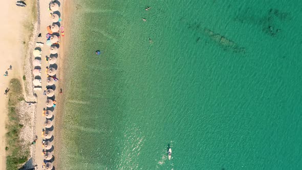 Aerial view of people enjoying summer day at Baska beach, Croatia.