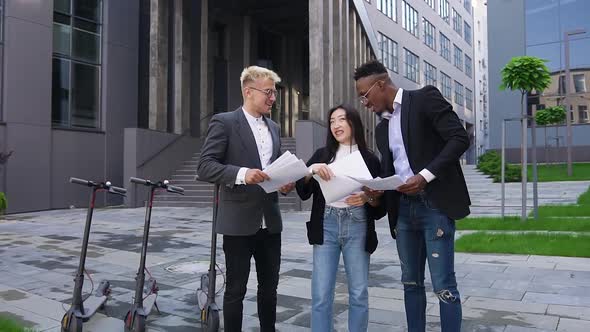 Happy Confident Successful Multiracial Colleagues Throwing Up Financial Documents Outdoors