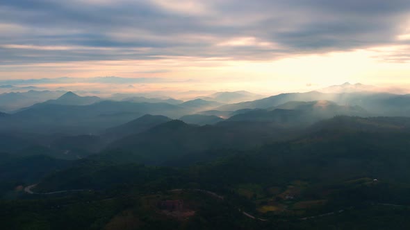 4K Flying through the clouds above mountain tops