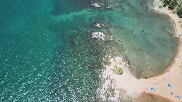 Drone flying over popular Zephyr cove marina, Nevada. Lake Tahoe. While looking down at the clear wa