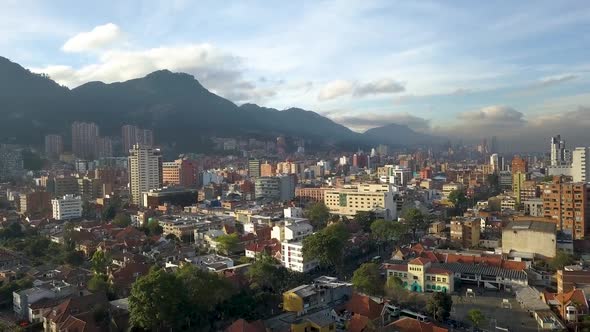 Aerial - Views of the skyline of Bogota, Colombia, surrounded by mountains