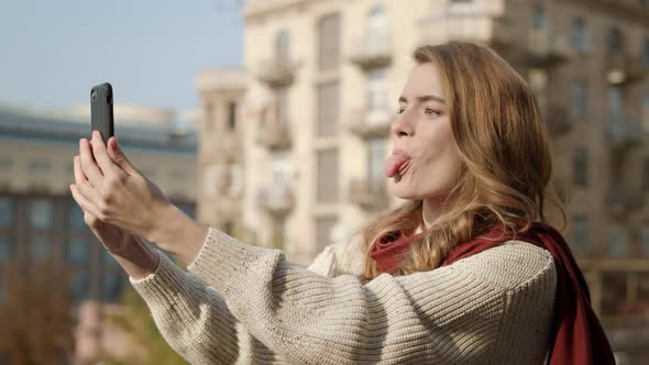 Pretty Girl Making Selfie Photo Outdoors, Funny Woman Using Cellphone on Street