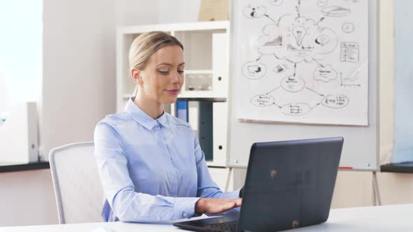 Businesswoman with Laptop and Smartwatch at Office 