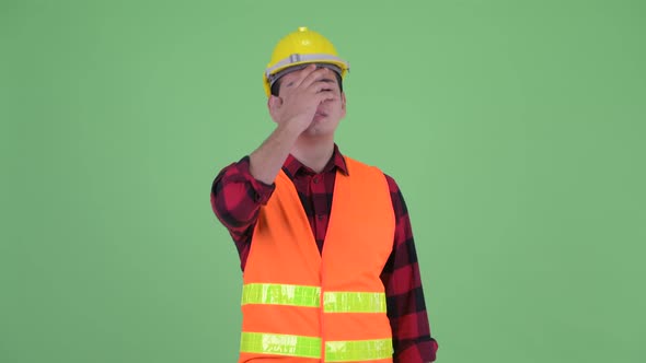 Stressed Young Multi Ethnic Man Construction Worker Getting Bad News