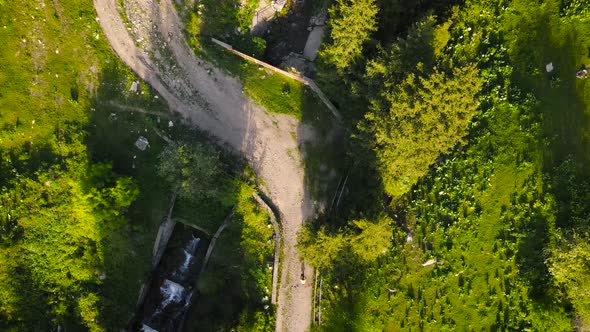 Aerial Forest Road and Bicyclist in the Mountain of Almaty