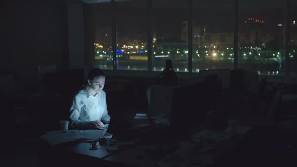 Tired Woman Working in Office at Night