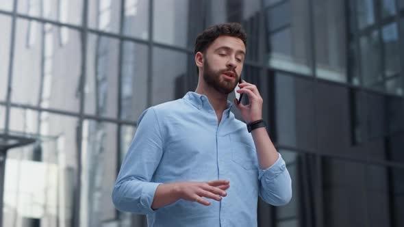 Attractive Man Ending Phone Call Outside Office