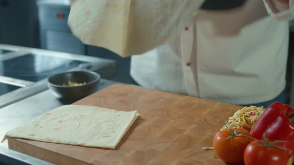 Hands of a Male Cook Preparation With Cheese and Vegetables a Doner Kebab