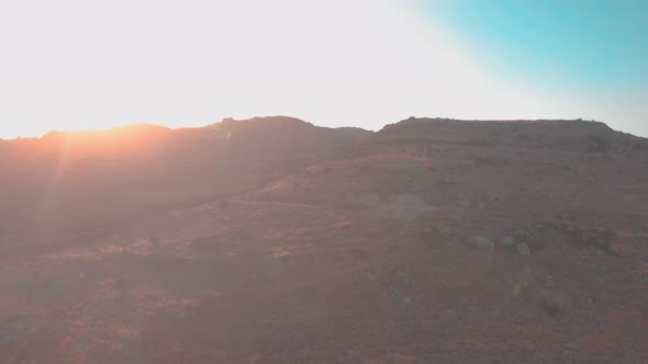 Drone flying down over mountains.