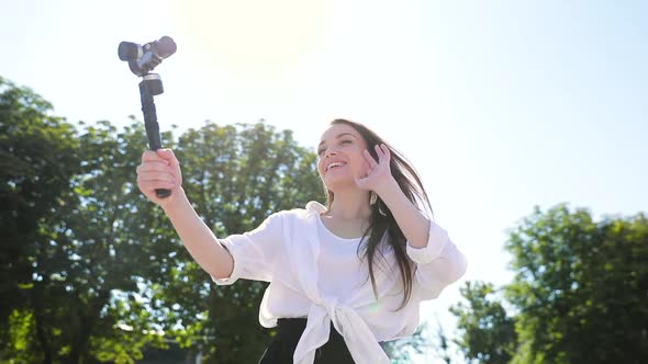 Woman Recording Video Blog On Camera On Street