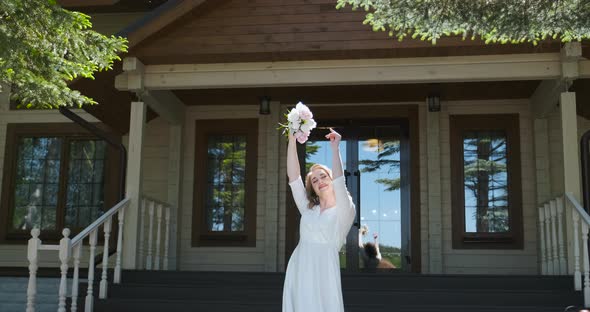 Dancing with Flowers Woman Wearing White Dress is Happy and Carefree