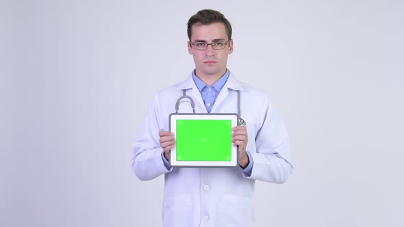 Young Happy Handsome Man Doctor Showing Digital Tablet