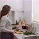 Young female cutting vegetables in the kitchen. Chopping vegetables for salad - VideoHive Item for Sale