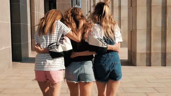 Three young female hipster friends posing outdoors