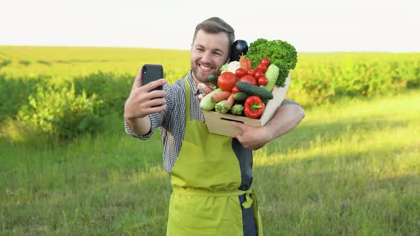 Successful Farmer Carrying Basket of Veg on a Sunny Day Makes a Selfie