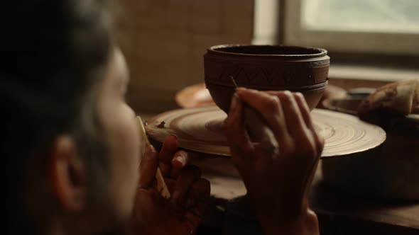 Unknown Woman Using Tools in Pottery