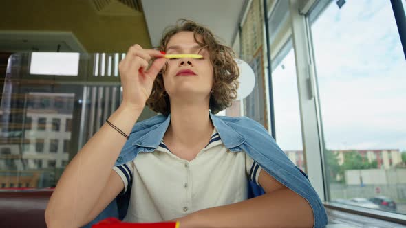 Cheerful Young Girl Make Grimace Play with Fries