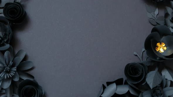 Black paper flowers on Black background. Cut from paper.