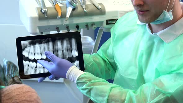 Dentist Moves the X-ray Image on His Tablet