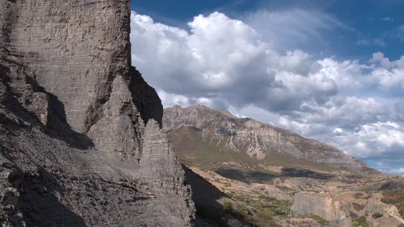 Flying towards rocky cliff face looking towards the sky