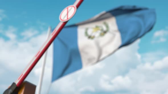 Barrier with STOP CORONAVIRUS Sign Closed at Flag of Guatemala alt